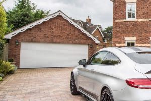 white roller shutter garage door with vehicle