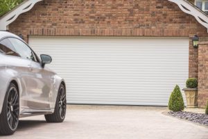 white roller shutter garage door with vehicle