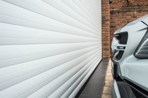 vehicle parked next to a roller shutter garage door