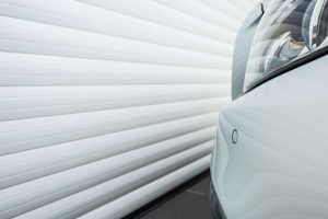 vehicle parked next to a roller shutter garage door