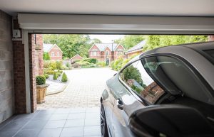 vehicle parked inside garage with a roller garage door