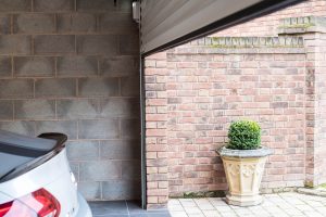roller shutter garage door closing with car inside